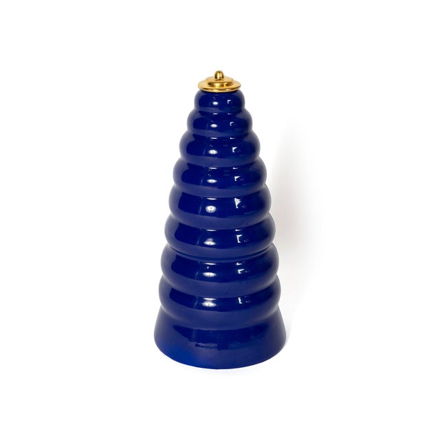 Covered vase with an ovoid silhouette, deep blue glaze, and a matching lid that extends the lines of the body. Designed by...