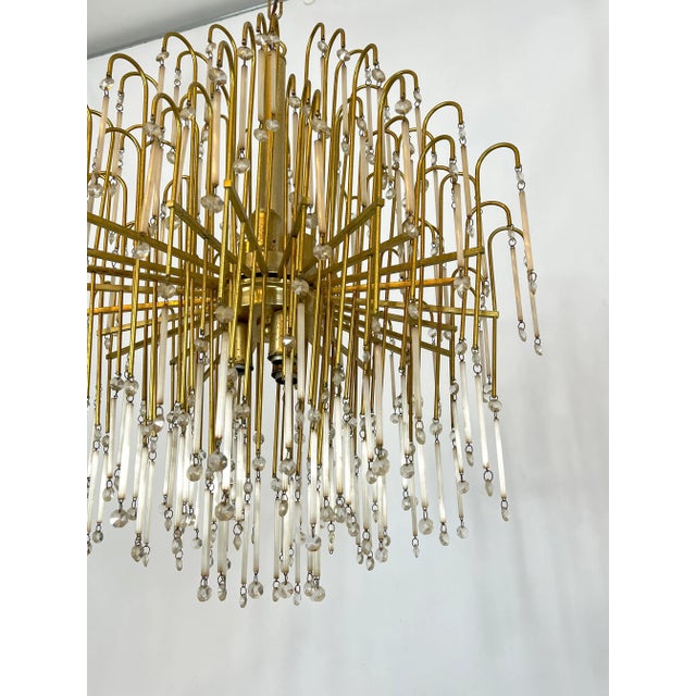 Large brass and glass chandelier produced in Italy during the 70s. Good vintage condition with trace of age and use....