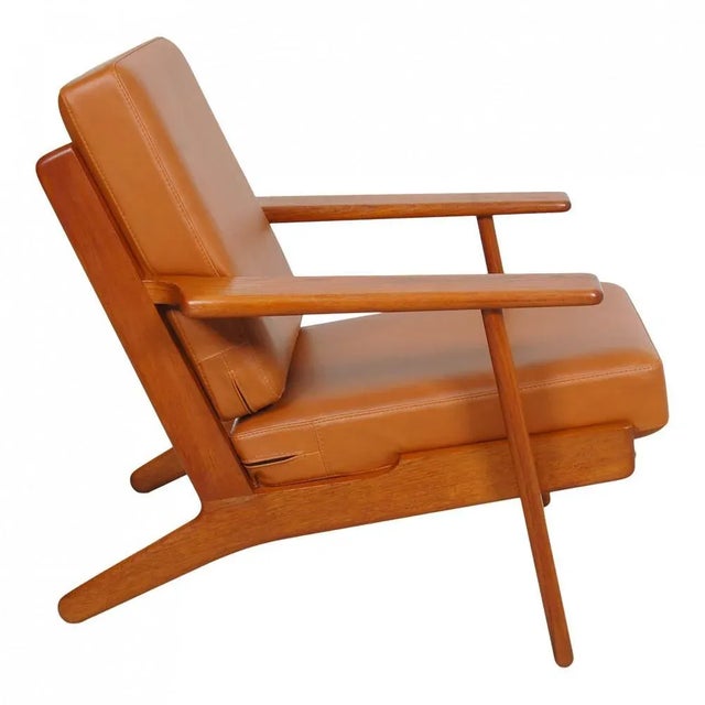 Hans Wegner Armchair model GE-290 with solid teak frame and new foam cushions upholstered in walnut aniline leather. The...