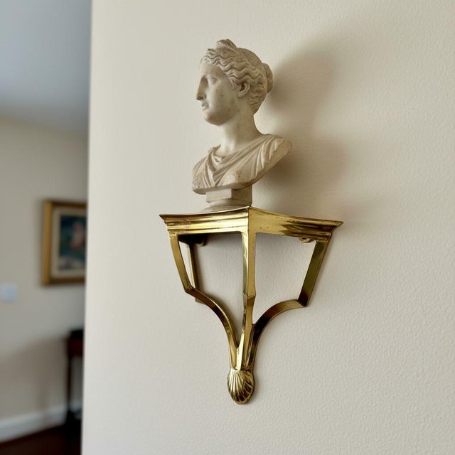 This elegant pair of brass wall shelves reflects the refined geometric lines popular during the late 20th-century revival...