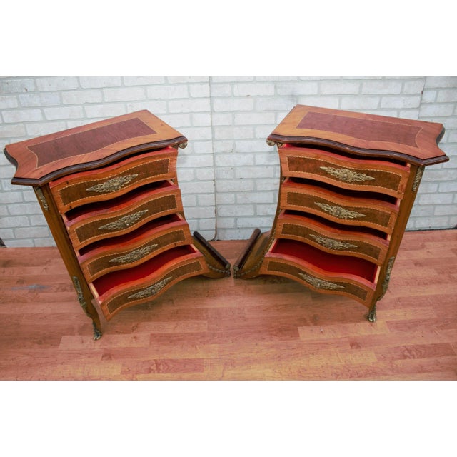 Vintage French Renaissance Revival flared legs bedside nightstands/side tables. This charming and unique pair of 4 drawer...