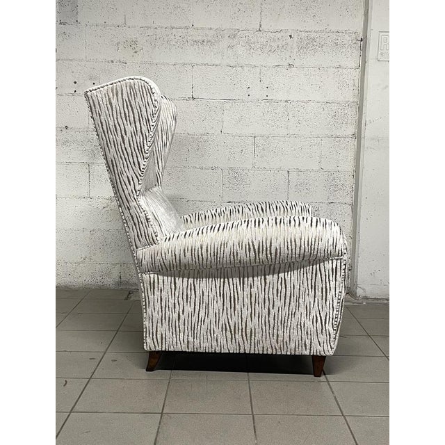 Large 1940s armchair with new worked velvet coating. Wooden feet. The new coating gives importance and modernity to a...