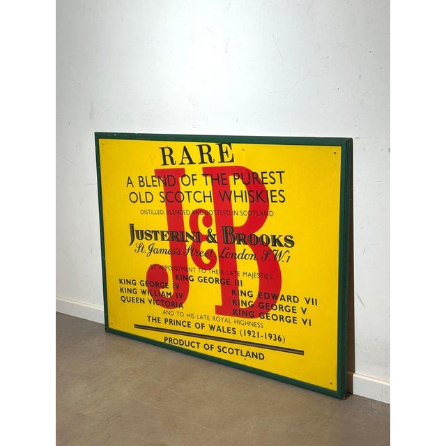 Large and striking vintage advertising sign for J&B Scotch Whisky, featuring the iconic yellow background with bold red...