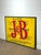 Large and striking vintage advertising sign for J&B Scotch Whisky, featuring the iconic yellow background with bold red...