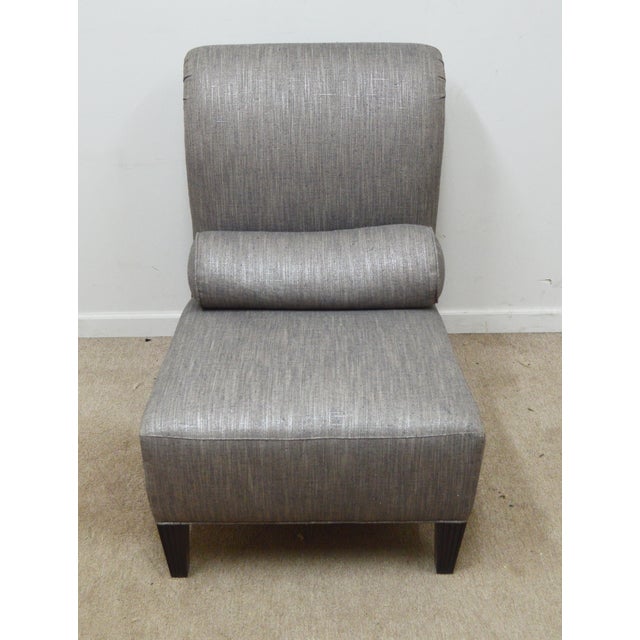 Slipper Chair by Baker. Store item #470. It features reeded legs and comes with a pillow.