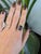 A 6.30-carat bi-color tourmaline emerald-cut sits at the centre of this solid 14K white gold ring, framed by twenty-six...