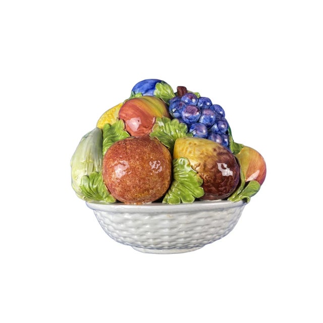 This Large Vintage Terra Cotta Glazed Della Robbia Woven Basket adorned with a luscious Fruit Assortment is a beautiful...