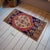 Vintage Turkish hand-knotted small rug from Oushak, Aegean, circa 1970, featuring warm terracotta tones and authentic...