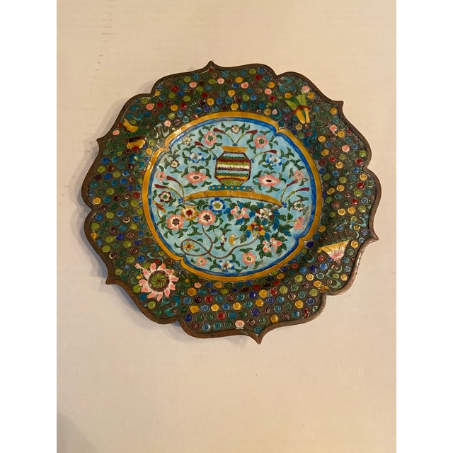 Cloisonné is a technique where delicate metal wires create compartments filled with enamel paste which is then fired....