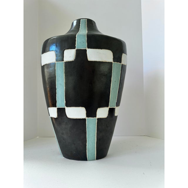 A striking signed handmade studio pottery vessel with a bold architectural presence. Finished in a graphic palette of...