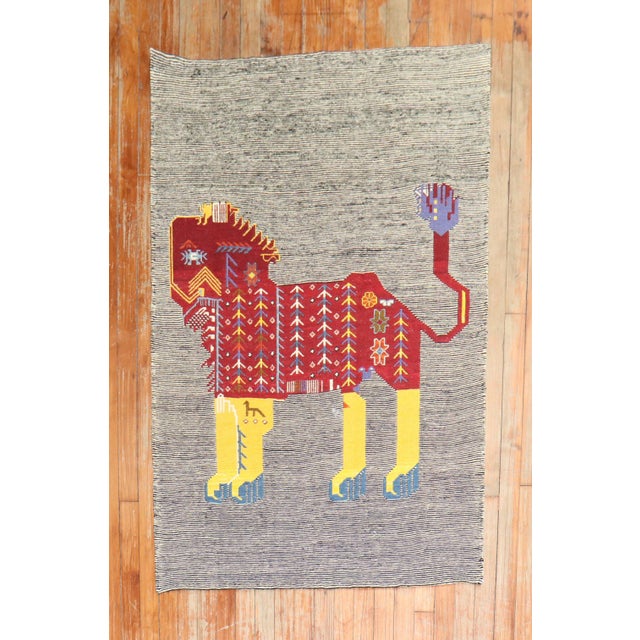 Scatter size Persian Kilim from the late 20th century with a lion on a striped field. can be used as a wall hanging too...