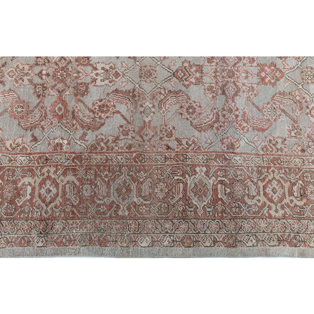 This 1900s antique Persian Sultanabad rug showcases the hallmark grandeur and artistry of Persian village weaving from...