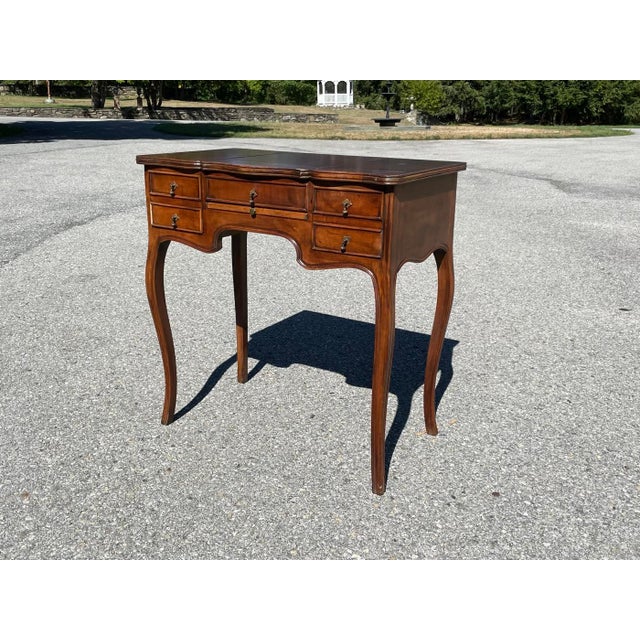 A vintage French style lift-top vanity with a serpentine-shaped top and apron, two drawers and cabriole legs. Product...