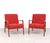A beautiful set of two Danish design armchairs from the 1950s, featuring an organically shaped wooden frame and warm...