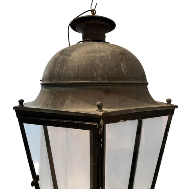 A striking 19th century French lantern crafted from iron and glass, featuring a generous scale and timeless architectural...