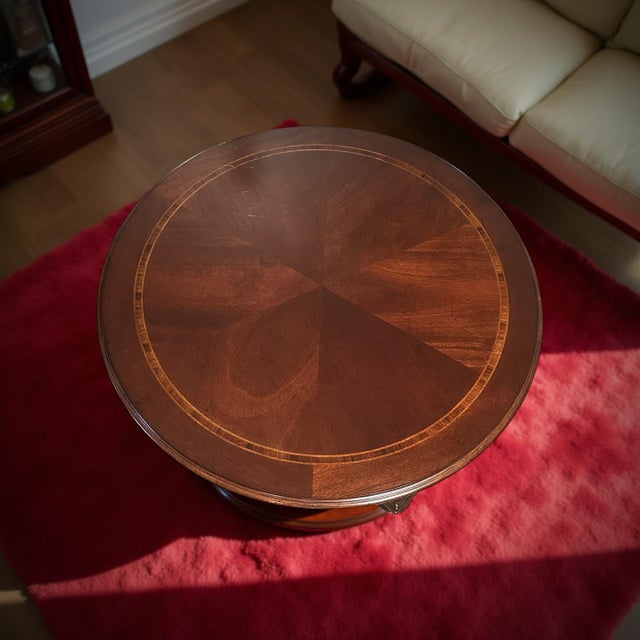 This vintage round mahogany pedestal table features a richly polished finish and elegant craftsmanship that captures...