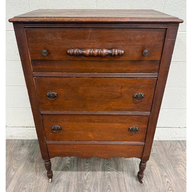 This is an antique late-Victorian walnut chest of drawers dating to the early 1900s. It features three spacious dovetailed...