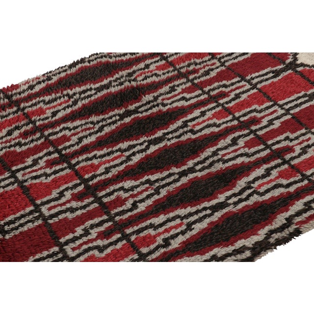 Hand-knotted in lush, high-pile wool in Sweden circa 1960-1970, this 5x7 vintage Swedish Rya rug is a bold new addition to...