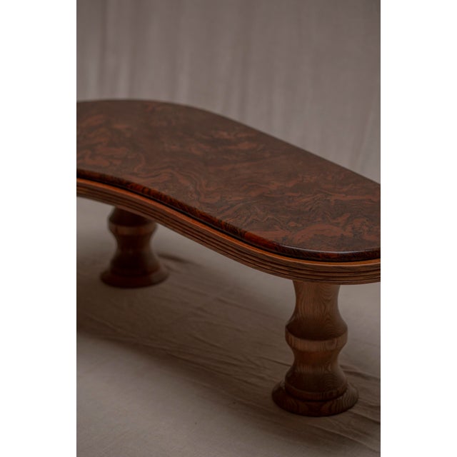 An elegant and sculptural boomerang-shaped coffee table, Belgium, dating from the 1970s. The organic silhouette gives the...