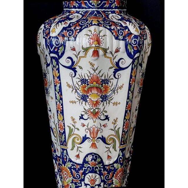 Each octagonal covered urn with large arching reserves adorned overall with floral and foliate stems; all raised on a...