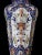 Each octagonal covered urn with large arching reserves adorned overall with floral and foliate stems; all raised on a...