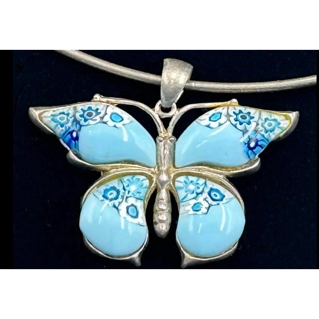 Vintage Alan K signed millefiori Murano glass butterfly pendant set in sterling silver. Dangles from a sterling omega...