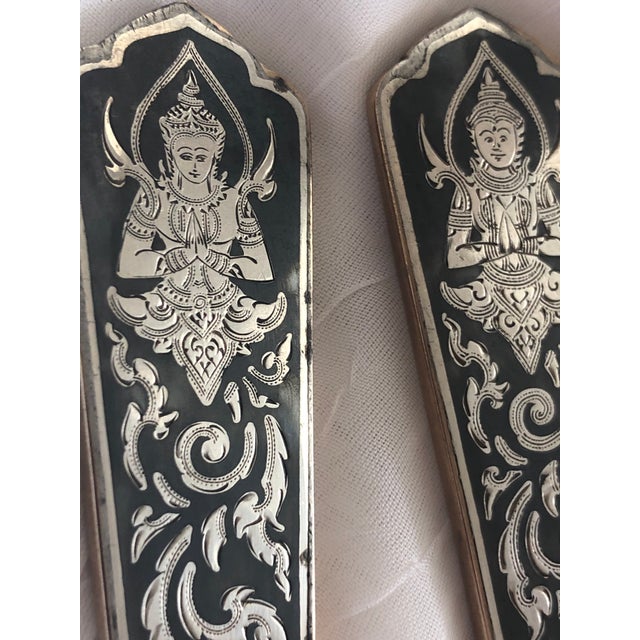 This lovely serving set is a vintage mid century export from Siam. Gods are featured in engraved sterling silver plates...