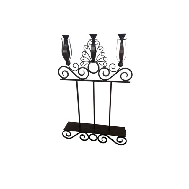 An impressive wrought iron floor three candle holder. Substantial with beautiful details and desirable patina.