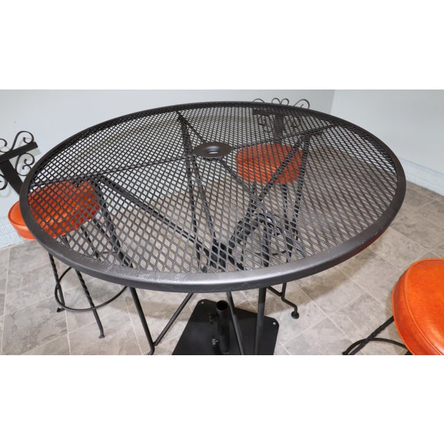 Vintage Spanish Revival Wrought Iron Swivel Bar Stool Set With Matching Mesh Bar Table & Heavy Umbrella Stand – Mid-Century, Orange Vinyl For Sale - Image 6 of 12