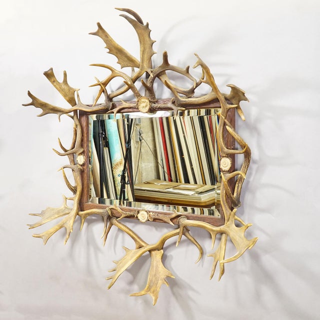 Antique Black Forest Mirror with Antler Arrangement ca. 1920s Item e8181 This impressive oversized wall mirror is crafted...