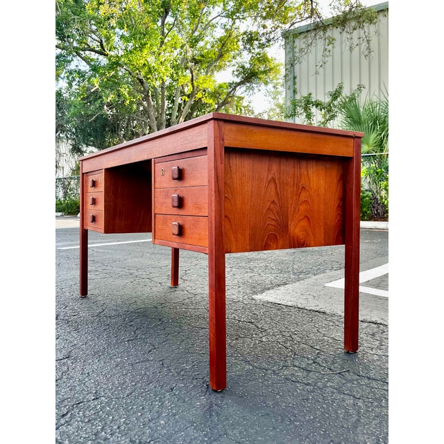 Mid-century Danish modern teak writing desk by Domino Møbler. Two main drawer banks with six drawers total. The top...