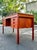 Mid-century Danish modern teak writing desk by Domino Møbler. Two main drawer banks with six drawers total. The top...
