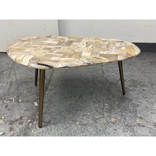 Design Plus Gallery presents the Denham Coffee Table from Made Goods. The Denham coffee table's pebble-shaped top is made...