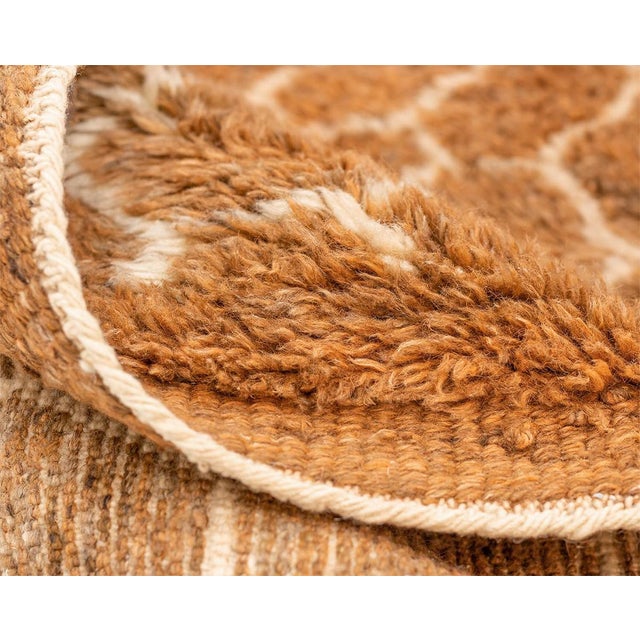 Exquisite hand-knotted rug with a honeycomb-inspired pattern in a rich spectrum of Honey Ginger and Deep Taupe, offering a...