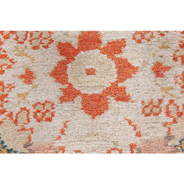This exquisite antique Turkish Oushak rug, dating from the early 1900s, is a stunning example of traditional Turkish...