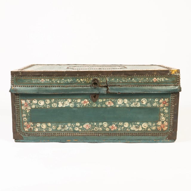 Decorated blue leather covered camphor wood trunk, bound with brass and mounted with cast brass bail handles. China, made...