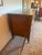 An exceptional, period-made 19th-century French Louis XVI style commode masterfully crafted with radiant burl walnut...