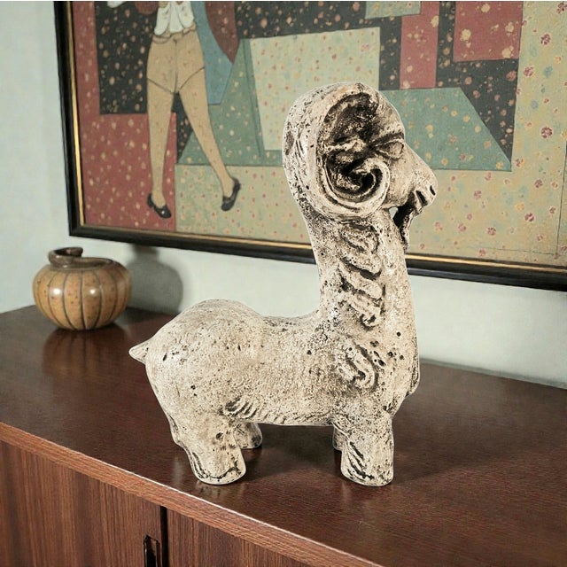 A commanding mid-century museum-style ram sculpture executed in textured Durastone composite, presenting the classical...