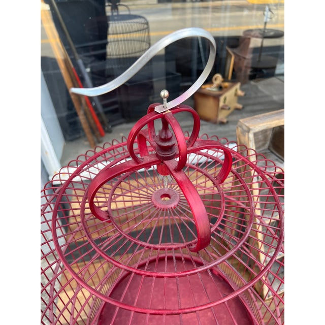 Vintage Birdcage in a Red Color and Wonderful Design to sit or Hang . The cage is designed to be able to turn like a...