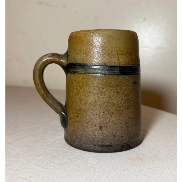 This rare antique 19th century cobalt glazed stoneware pottery mug is an handmade piece with a lovely silhouette. Made...