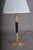 A sleek and sophisticated mid-century desk lamp of genuine architectural refinement — a polished circular brass base and...