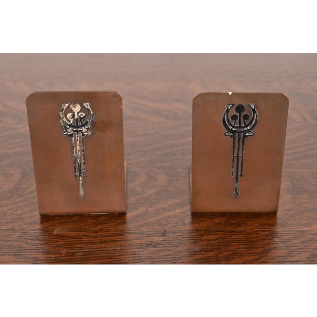 A beautiful pair of Arts & Crafts period sterling silver on bronze bookends By Silver Crest (the mark of Smith Metal Arts...