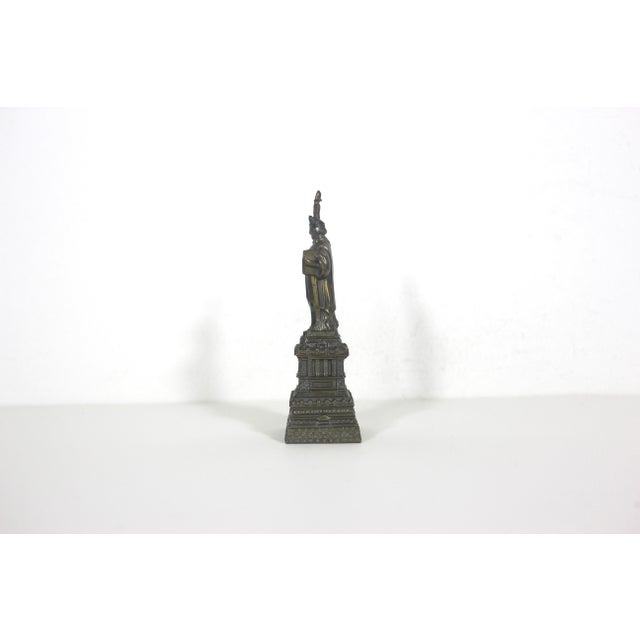 Small vintage gold metal Statue of Liberty souvenir of New York City. 4.5” tall 1.25” wide
