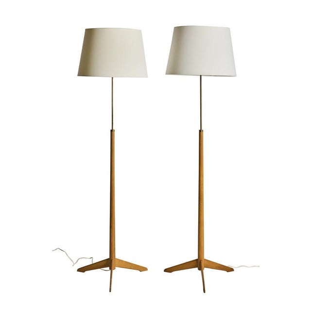 A pair of model g-34 floor lamps designed by alf svensson for bergboms, sweden, circa 1950s. An elegant matched pair of...