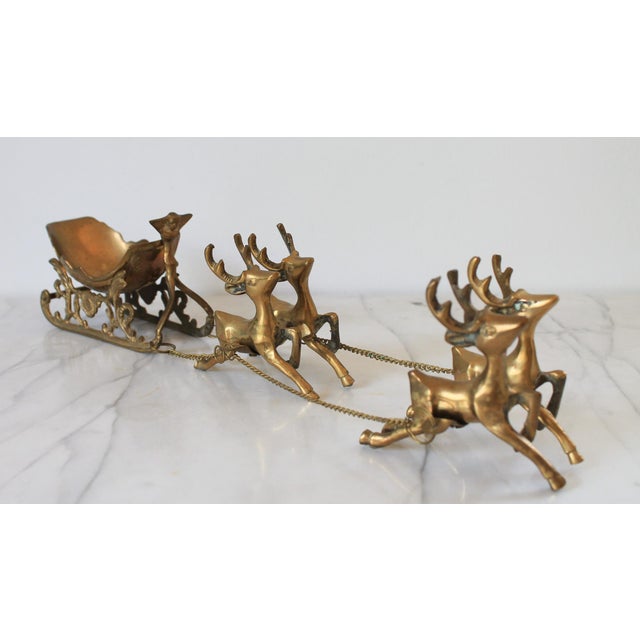Vintage brass sleigh and four reindeer with removable dish. Makers mark is partially worn off. Patina to brass.