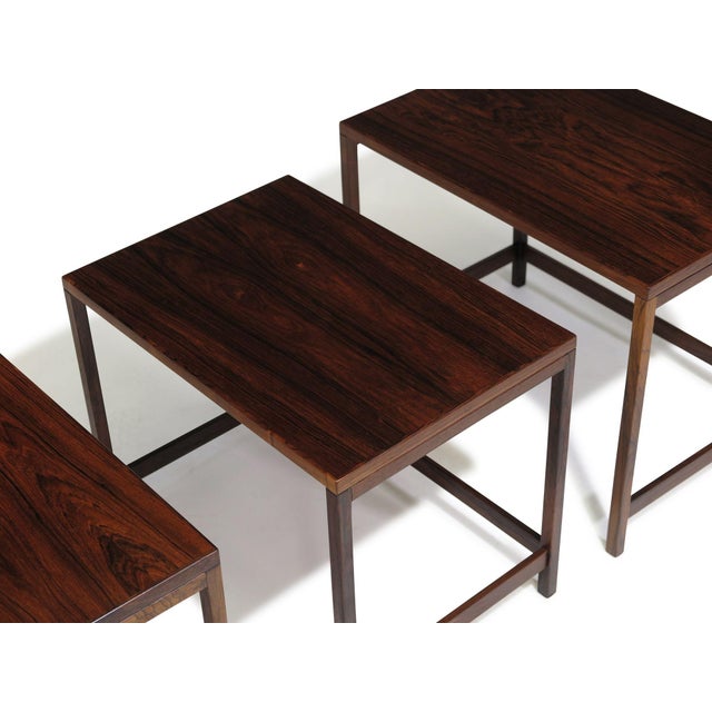 Set of three Danish Modern nesting tables c 1955, Denmark. Finely handcrafted of richly figured Brazilian rosewood with...