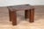 A vintage Javanese wooden bench from the mid-20th century, with raised motifs and straight legs. Born on the island of...