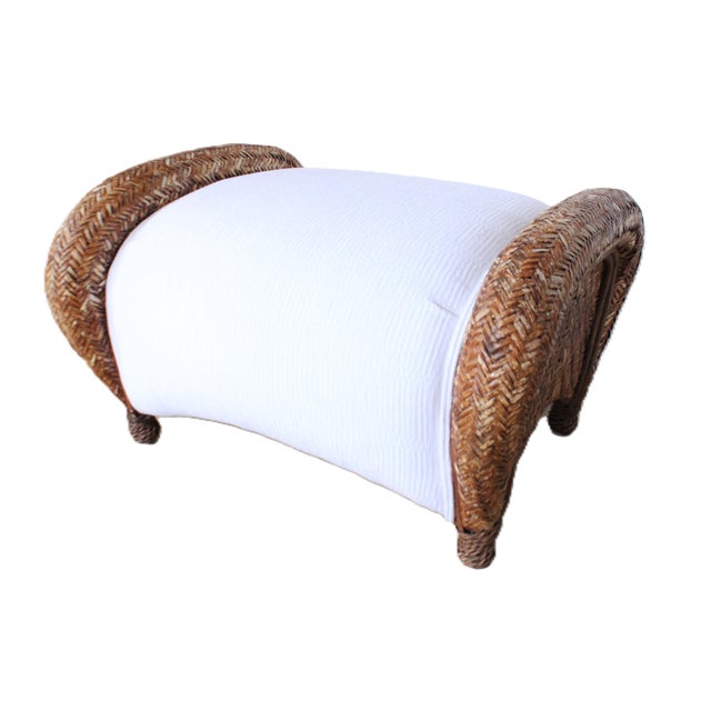 Contemporary rustic rattan ottoman. We love the aged patinated rattan frame with it's stylish oversized rolled arm's....