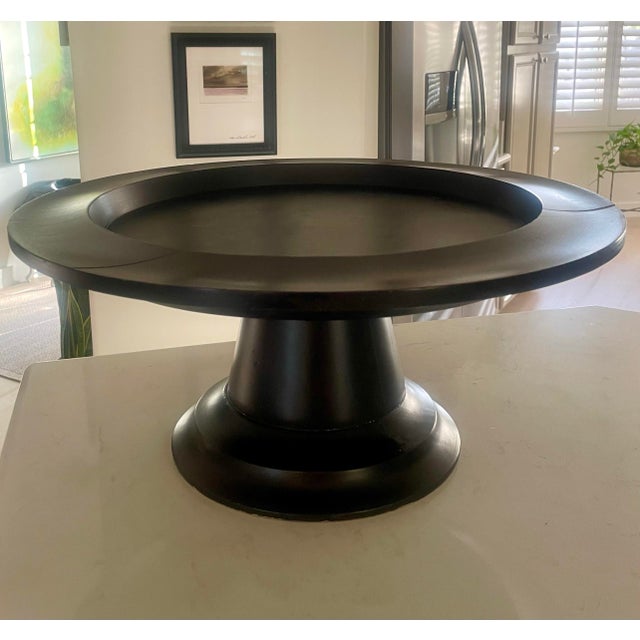 Mid 20th Century 21" Ebonized solid wood pedestal tray. The stand has a minimalist, modern aesthetic often used to elevate...