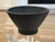 Hand thrown studio pottery bowl in a deep charcoal black matte finish on raised foot with subtle concentric throwing marks...